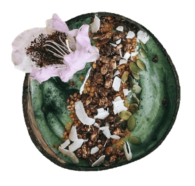 Super Greens Powder mixed with nuts with coconut on top