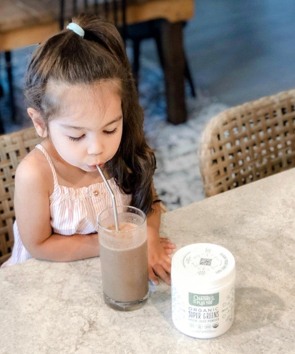 Young girl enjoying a Chocolate Super Greens smoothie